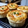 Mini turkey and veggie puff pies on a rustic table