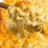 A close-up of creamy, golden-baked Tini’s Mac and Cheese being scooped from a casserole dish, with melted cheese stretching from the spoon.