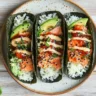 Sushi tacos served with nori shells, salmon, avocado, and rice