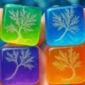 Four translucent, colorful square tiles held in a hand, each featuring a delicately etched tree design in shades of green, blue, purple, and orange.