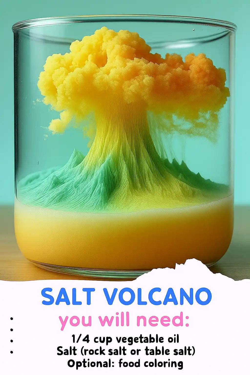 A vibrant, colorful "salt volcano" experiment in a clear glass container. Layers of oil and colored liquid create a volcano-like eruption, with a fluffy cloud of yellow and orange rising from green peaks.